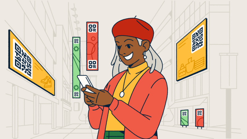 A woman standing in a city with digital advertisements featuring QR Codes around her. She's holding a smartphone in her hands.