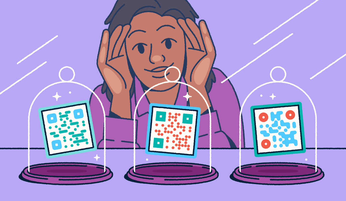 A person looking through a store-front window at three different QR codes on display in glass cloches.