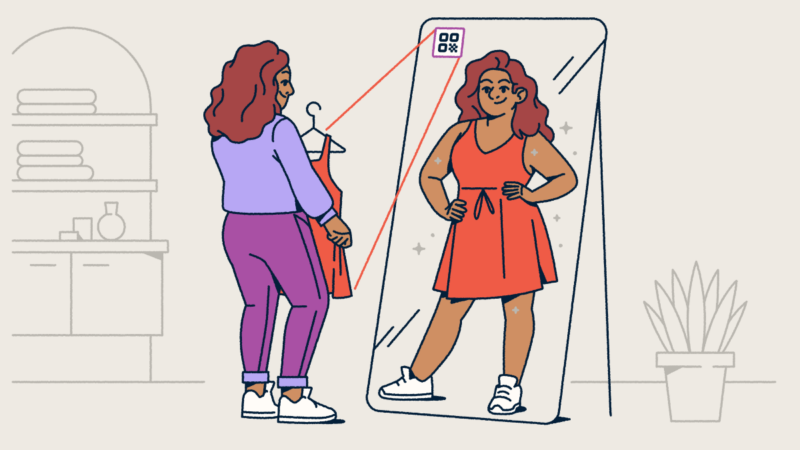 A woman in a purple outfit standing in front of a floor-length mirror with an AR QR Code on it. She's holding a red dress that's from the QR Code, and her reflection shows her in the dress.